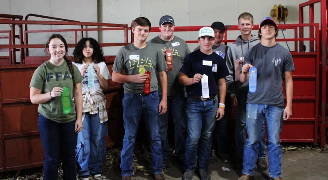 Individual FFA members receiving their ribbons (Far left) Megan Schlitter 5th, (Center Front) Ben Buhr 2nd, (Back Row Center) Andrew Pingenot 8th, and (Right Back Row) Will McKenna 7th
