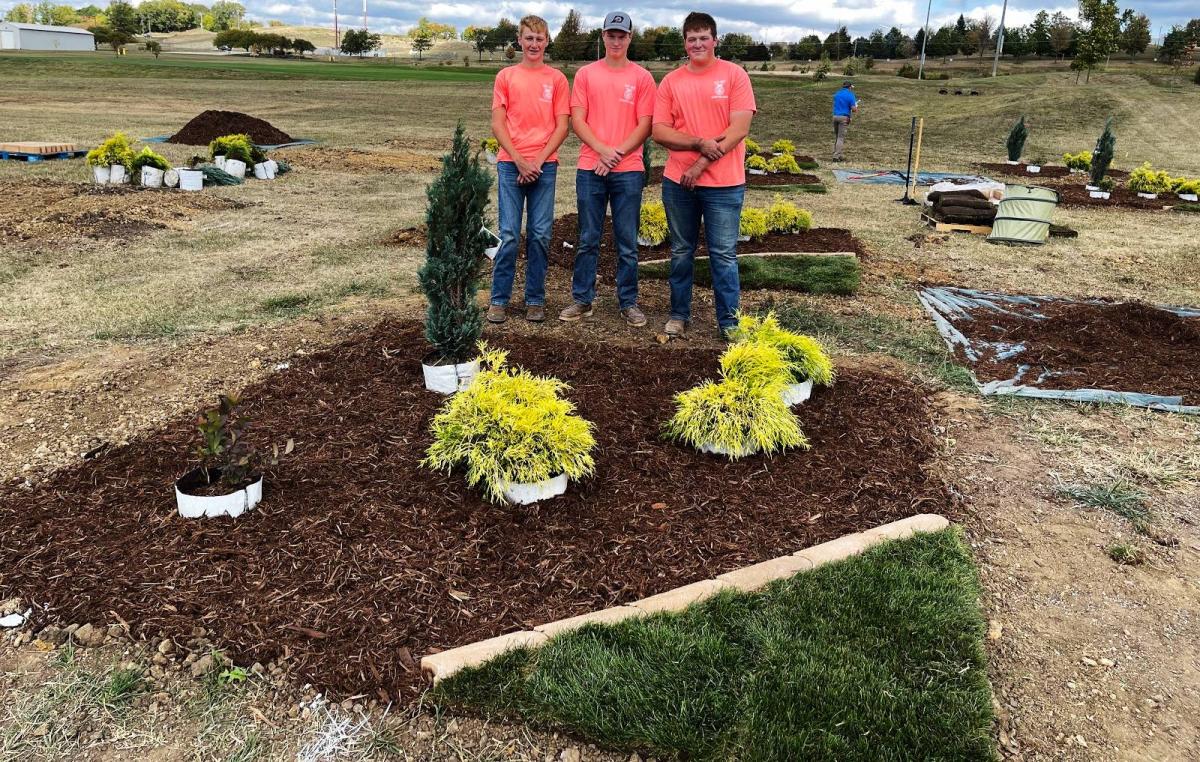 Ben McGowan, Wes McKenna, and Andrew Pingenot show off their team’s Plant Installation Challenge.