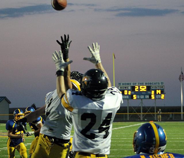 Max Kearns (24) leaps to intercept a pass in the end zone.