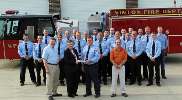 Darlys Hulme of Farmers Savings Bank presents a $1,000 check to the VFD in honor of Charles Yundt.