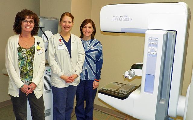 Monica Stark, Maria Davis and Sarah Kindschi pose with the new mammography unit at VGH.