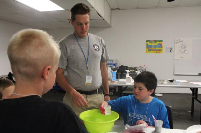 NCCC Member Tyler prepares a bubble solution with third and fourth graders during Slime Time class