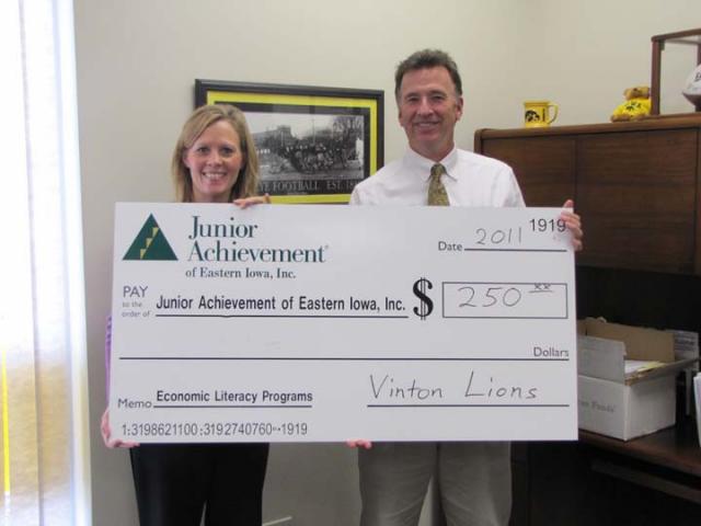 Jeff Peterson, Vinton Lions Club presents Barb Rawson, Junior Achievement with a donation for JA