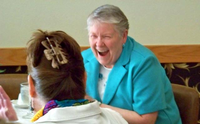 Virginia Holsten reacts with happiness and surprise as she learned she was named Woman of the Year.
