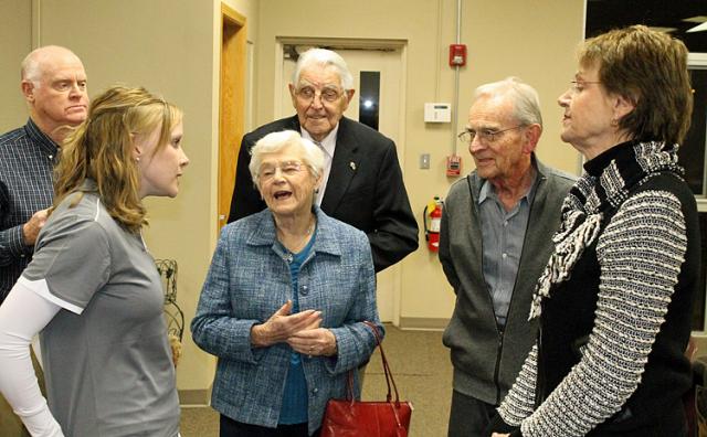 VU Director Melissa Schwan speaks to the Pedersons before the annual meeting.