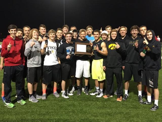 Viking track team members celebrate with the Wamac Super Meet Trophy.