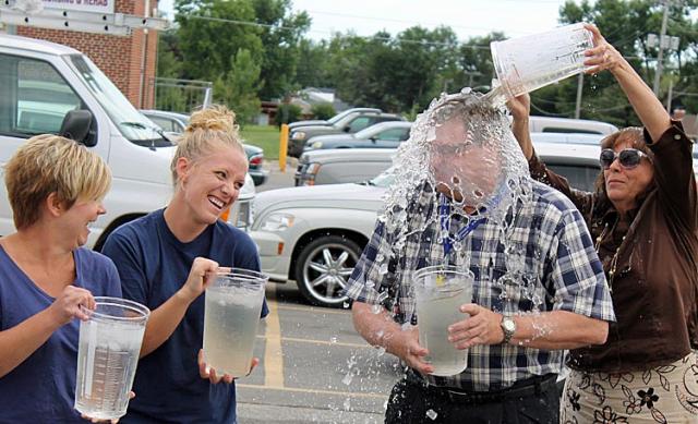 Denise Evans and Jess Albertson watch as Dr. Gene Laviere gets soaked by Lori Smith.