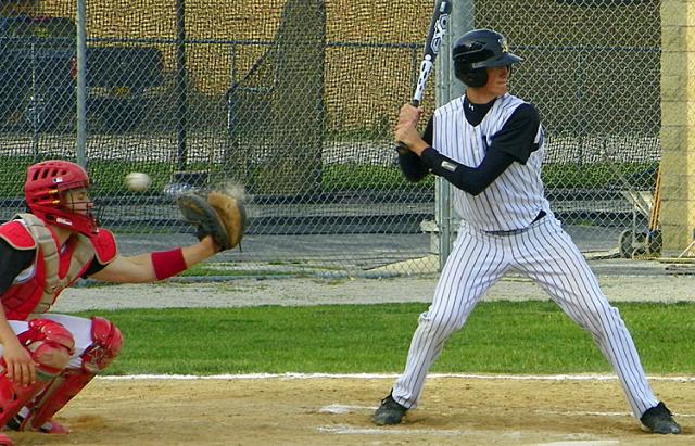 The ball bounces off the glove of the Raider catcher.