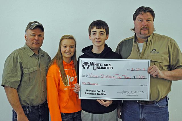 Whitetails Board members Lenny Engelking and Jared Vogeler present $1,000 to Sara & Kyle Jorgensen.
