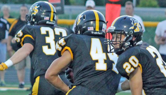 Jordan Womochil hands off to Joel Barnes early vs. S. Tama. 